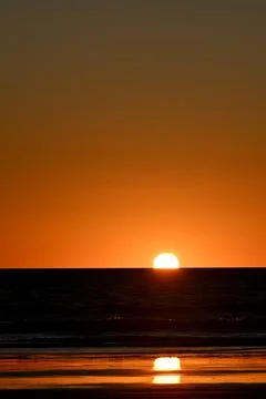 Sunset on a beach Stock Photos