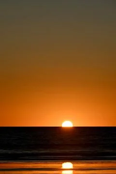 Sunset on a beach Stock Photos