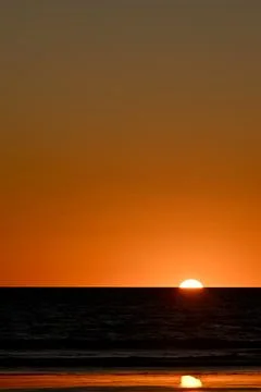 Sunset on a beach Stock Photos