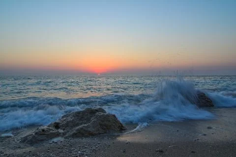 Sunset on a beach Stock Photos