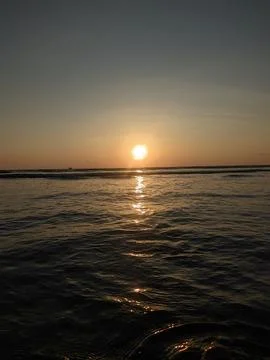 Sunset on a beach Stock Photos