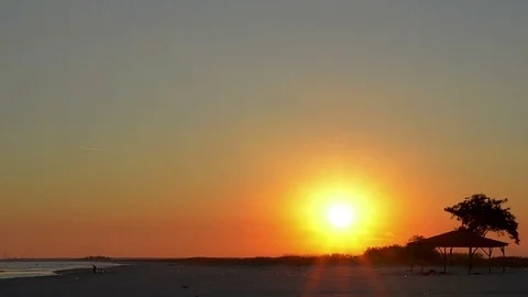 Sunset on the beach, red and orange colors as the sun hiding at horizon Stock Footage 69859117