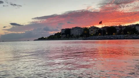 Sunset on the beach. Red sunset and waves, Turkish flag Stock Footage 221165604