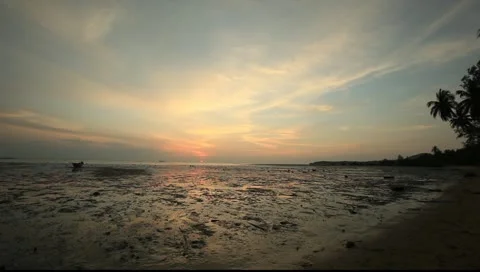 Sunset at the beach with reflections on the water at low tide @ Thailand Stock Footage 10988501