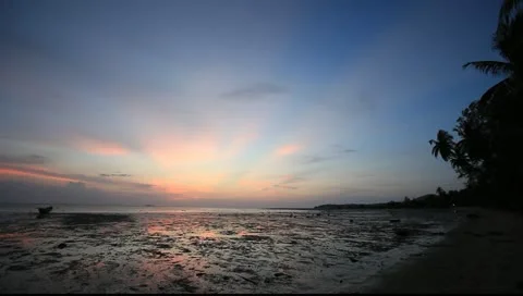 Sunset at the beach with reflections on the water at low tide @ Thailand Stock Footage 10988752
