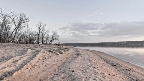 Sunset on the beach of the river with devias on the shore and clouds Stock Footage 125103191