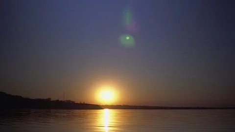 Sunset on beach of the river or lake, waves water close up, evening sky Stock Footage 132373872