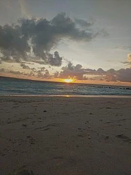 Sunset Beach with Rolling Waves and Golden Reflections Stock Photos