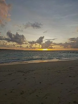 Sunset Beach with Rolling Waves and Golden Reflections Stock Photos
