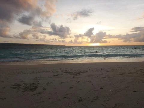 Sunset Beach with Rolling Waves and Golden Reflections Stock Photos