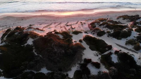 Sunset beach sand dunes ocean holiday travel aerial footage Stock Footage 115689151