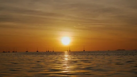 Sunset on the beach scene of a golden sunset over the sea Stock Footage 104235906