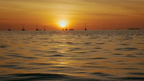 Sunset on the beach scene of a golden sunset over the sea Stock Footage 104236414