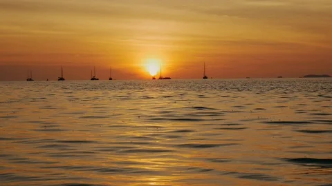 Sunset on the beach scene of a golden sunset over the sea Stock Footage 104236458