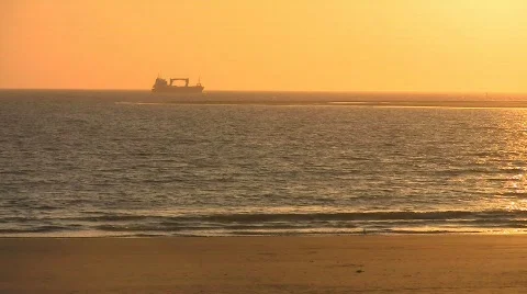 Sunset at beach, ship in background Stock Footage 708642