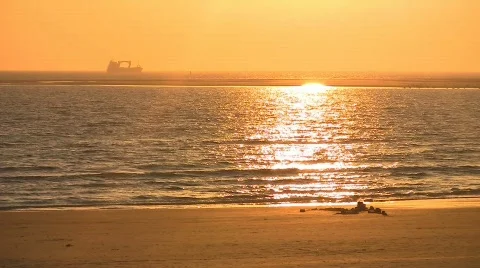 Sunset at beach, ship in distance Stock Footage 708653