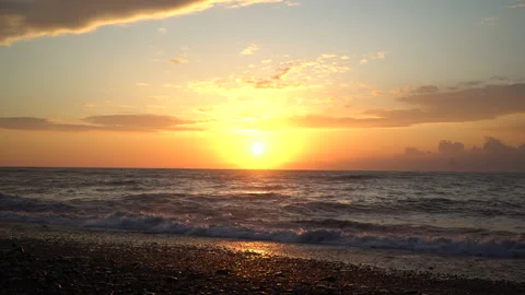 Sunset Beach shore with pebbles, sand on the sunset with waves crushing Stock Footage 180952245
