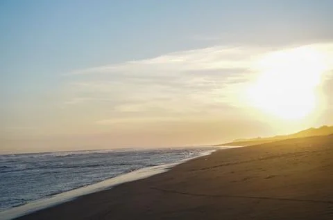 Sunset Beach Shoreline With Ocean Waves Stock Photos