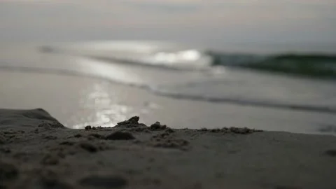 Sunset on the beach is the slow movement of foamy waves rolling towards the Stock-Footage 166167183