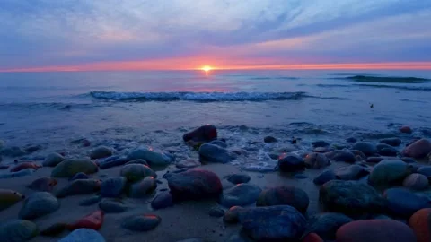 Sunset by the beach with slow moving waves and warm summer light. Stock Footage 201011502