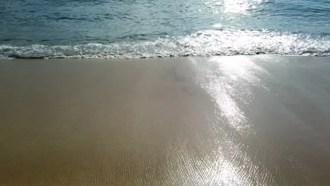 Sunset at the beach with the sun reflecting on the waves. Golden sand Video stock 167484609