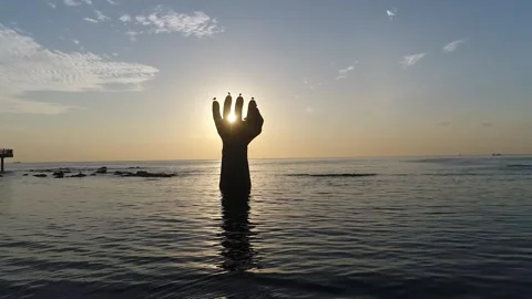 Sunset on the beach, sunset on the ocean with hand Statue Stock-Footage 310930626