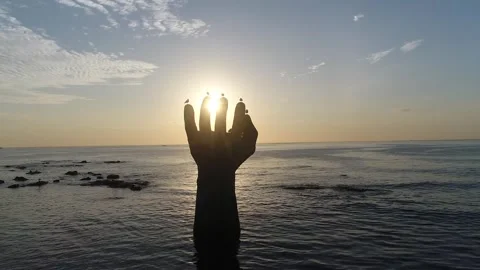 Sunset on the beach, sunset on the ocean with hand Statue Video stock 310930635