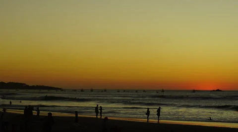 Sunset beach time-lapse sunsetting people walking on beach Stock Footage 61930035