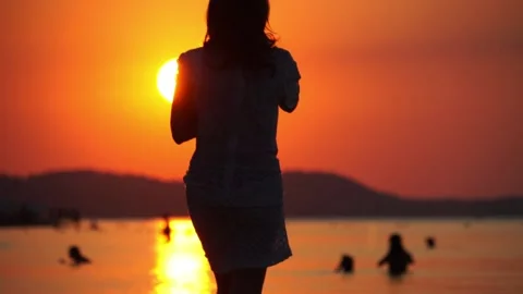 Sunset on Beach with Tourists Stock Footage 156829701