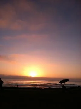 Sunset with beach umbrella. Stock Photos