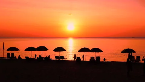Sunset beach umbrellas colorful dramatic silhouette sky island. Stock Footage 208632850