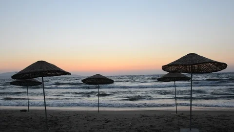 Sunset on beach umbrellas Stock Footage 114189668