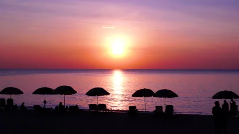 Sunset beach umbrellas silhouette sky. Stock Footage 208632603