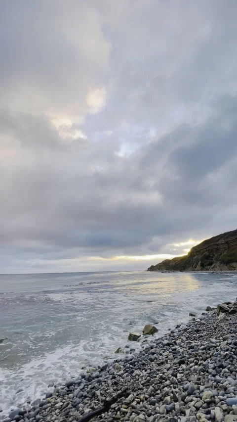 Sunset Beach View of the Pacific Ocean and Storm Clouds Overlooking Natural Reef Stock Footage 244093950