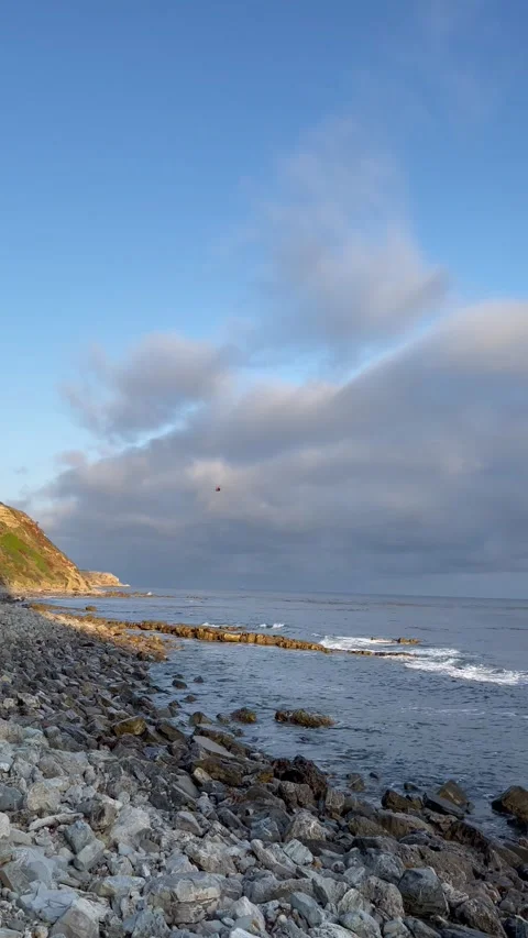 Sunset Beach View of the Pacific Ocean and Storm Clouds Overlooking Natural Reef Stock Footage 244094055