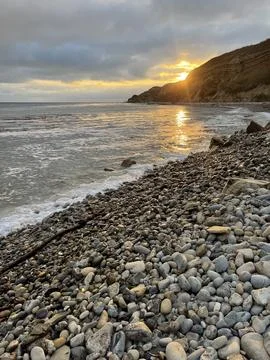 Sunset Beach View of the Pacific Ocean and Storm Clouds Overlooking Natural Reef Stock Photos