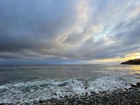 Sunset Beach View of the Pacific Ocean and Storm Clouds Overlooking Natural Reef Stock Photos