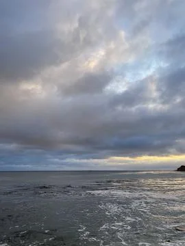 Sunset Beach View of the Pacific Ocean and Storm Clouds Overlooking Natural Reef Stock Photos