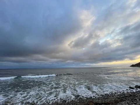 Sunset Beach View of the Pacific Ocean and Storm Clouds Overlooking Natural Reef Photos