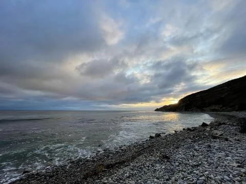 Sunset Beach View of the Pacific Ocean and Storm Clouds Overlooking Natural Reef Stock Photos
