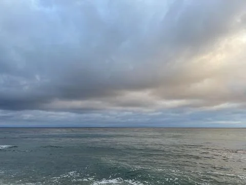 Sunset Beach View of the Pacific Ocean and Storm Clouds Overlooking Natural Reef Photos