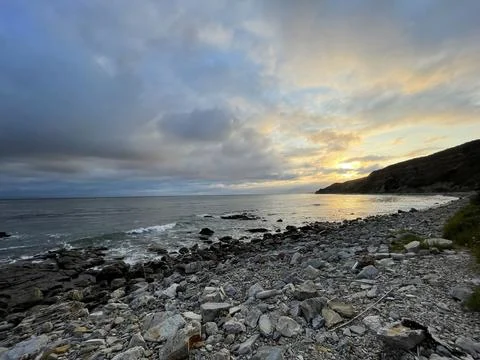 Sunset Beach View of the Pacific Ocean and Storm Clouds Overlooking Natural Reef Photos