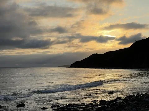 Sunset Beach View of the Pacific Ocean and Storm Clouds Overlooking Natural Reef Photos