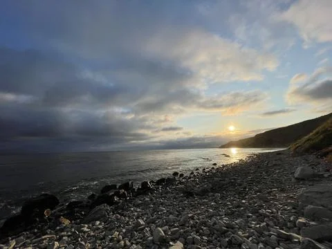 Sunset Beach View of the Pacific Ocean and Storm Clouds Overlooking Natural Reef Stock Photos