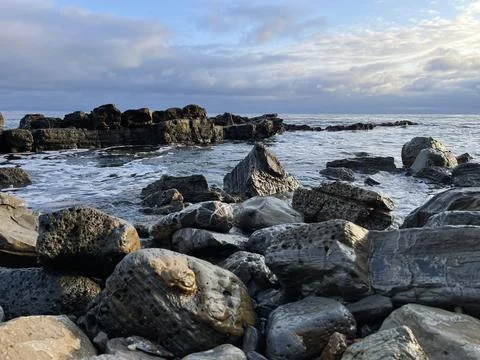 Sunset Beach View of the Pacific Ocean and Storm Clouds Overlooking Natural Reef Stock Photos