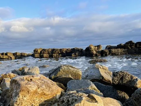 Sunset Beach View of the Pacific Ocean and Storm Clouds Overlooking Natural Reef Stock Photos