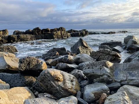 Sunset Beach View of the Pacific Ocean and Storm Clouds Overlooking Natural Reef Photos