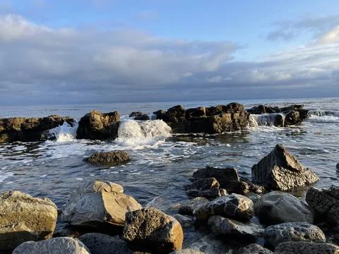 Sunset Beach View of the Pacific Ocean and Storm Clouds Overlooking Natural Reef Stock Photos
