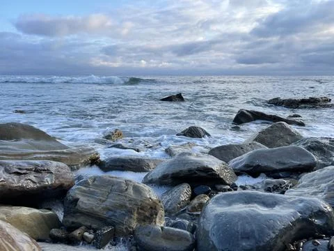 Sunset Beach View of the Pacific Ocean and Storm Clouds Overlooking Natural Reef Stock Photos