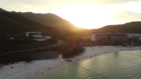 Sunset at the beach with a waterfront resort, drone footage Stockbeeldmateriaal 219276080